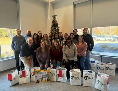 Group of employees by donated peanut butter jars